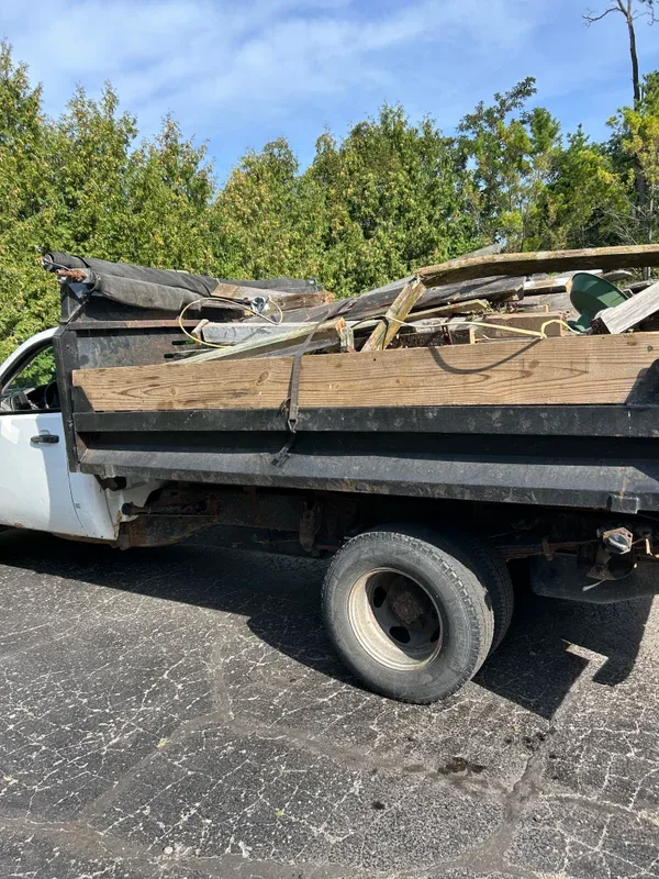 Truck bed loaded with lumber and salvaged debris