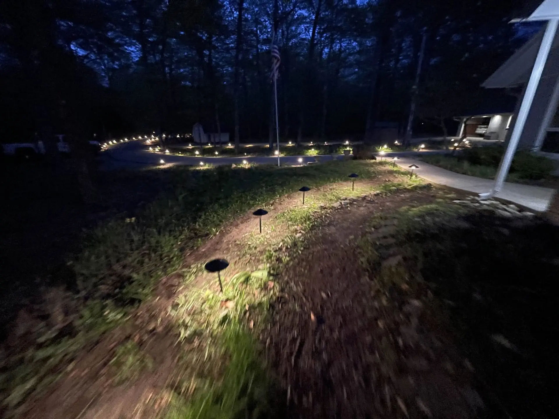 Finished property improvement with path lighting at dusk